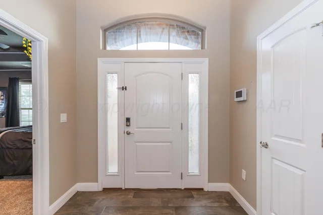 a view of front door with chandelier
