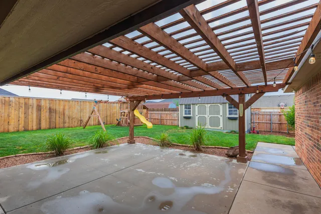 a view of a backyard with plants and barbeque area