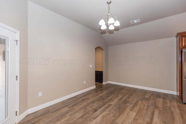 a large kitchen with stainless steel appliances granite countertop a sink a stove and a refrigerator