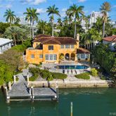 an aerial view of residential houses with outdoor space and swimming pool