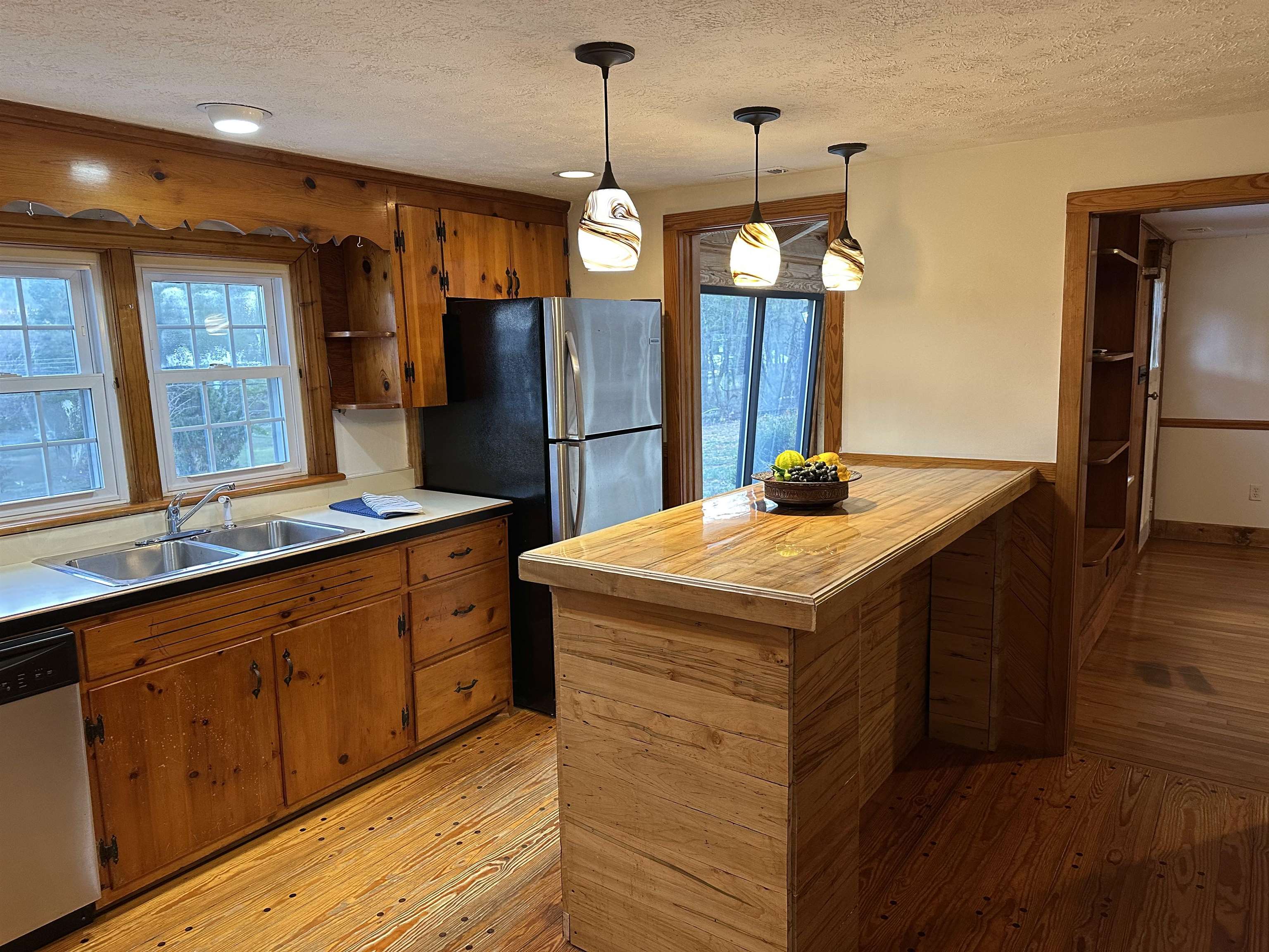 2205 Mt Torrey Road Lyndhurst, VA 22952 - Photo 27 of 43 a kitchen with stainless steel appliances kitchen island granite countertop a refrigerator a sink dishwasher a dining table and chairs with wooden floor