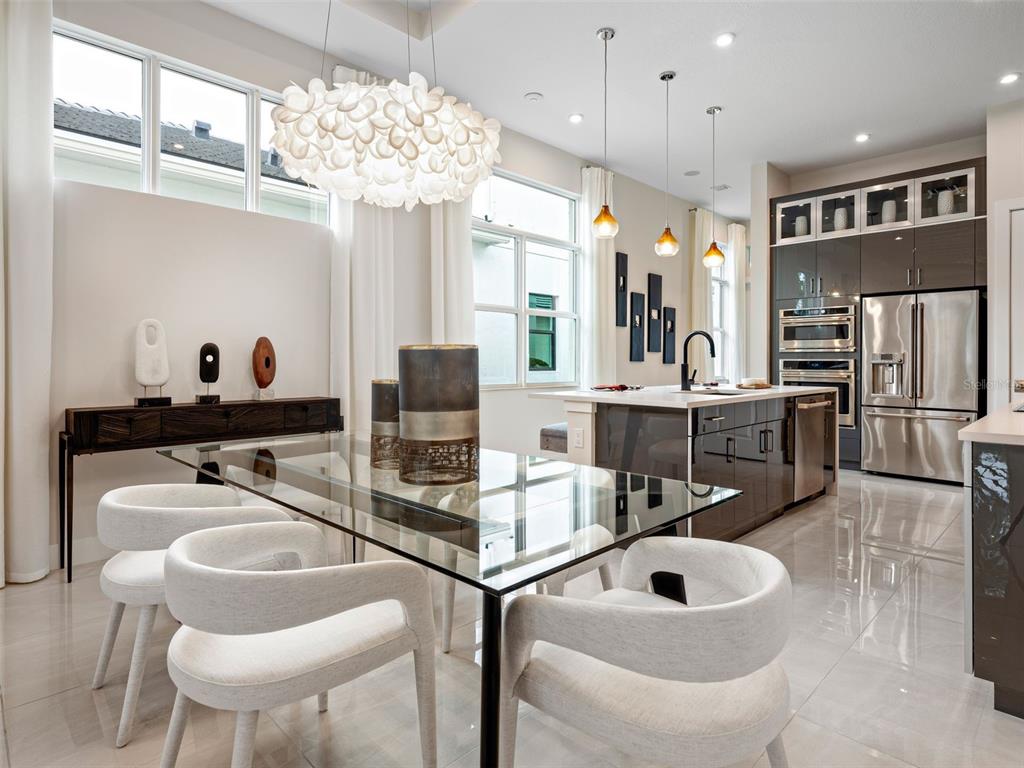 882 Liliana Drive Deland, FL 32724 - Photo 11 of 40 a kitchen with stainless steel appliances granite countertop a sink and refrigerator