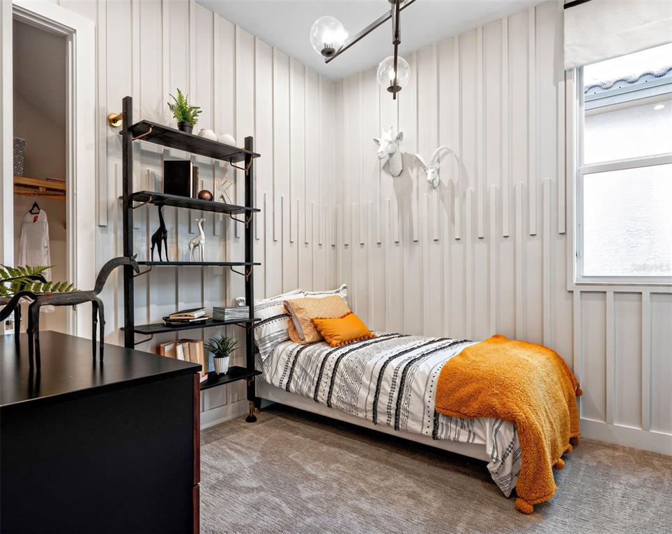 882 Liliana Drive Deland, FL 32724 - Photo 21 of 40 a bed room with a bed and a book shelf