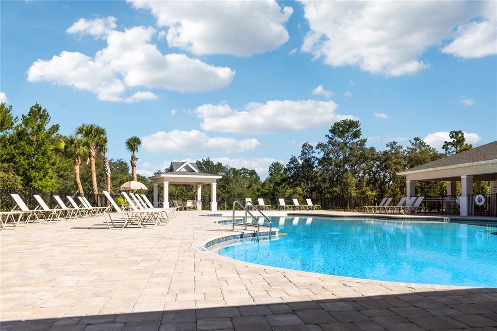 882 Liliana Drive Deland, FL 32724 - Photo 36 of 40 a view of a swimming pool with an outdoor space and seating area