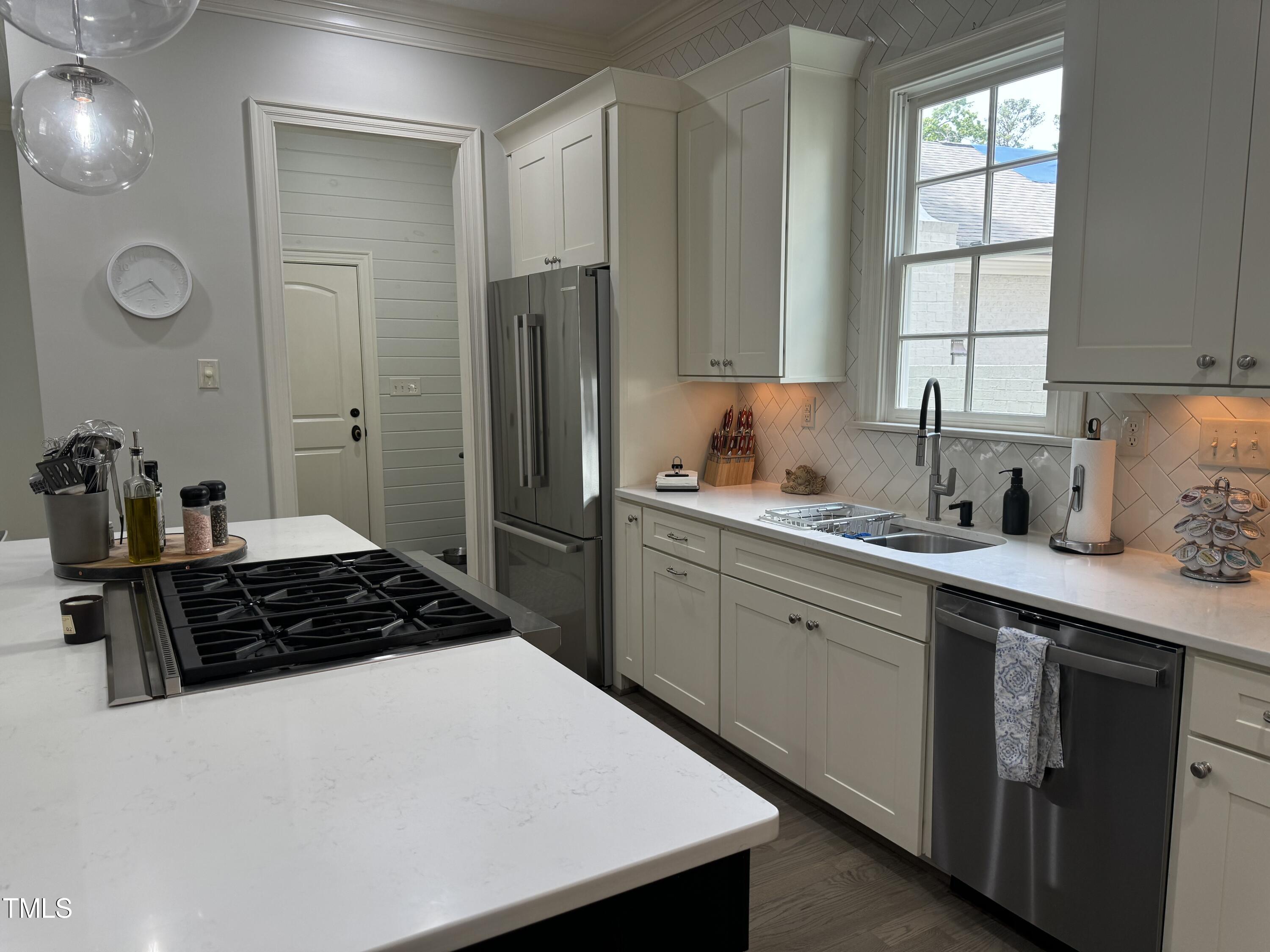 535 Guilford Circle Raleigh, NC 27608 - Photo 11 of 30 a kitchen with a sink stove and refrigerator