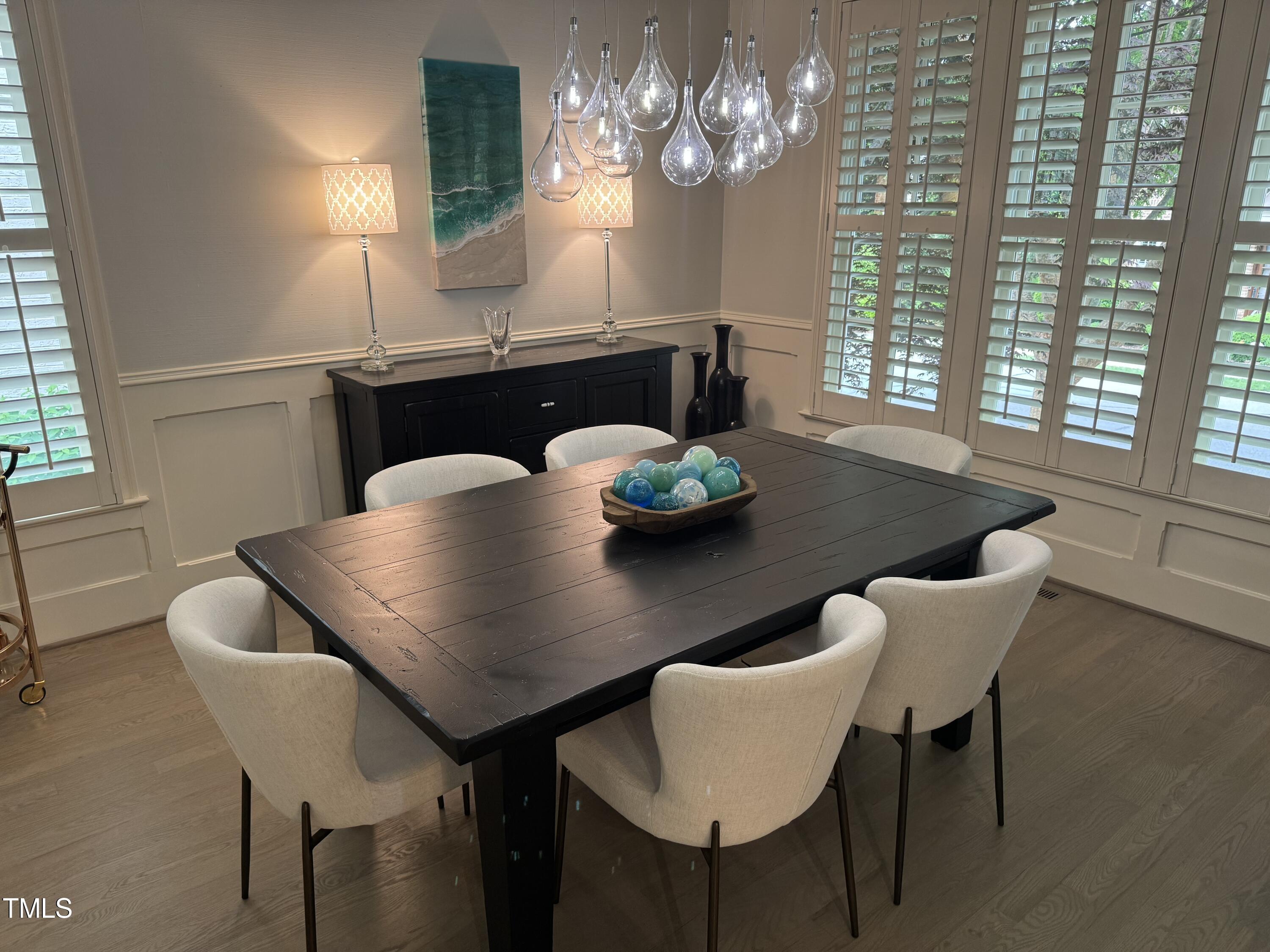 535 Guilford Circle Raleigh, NC 27608 - Photo 14 of 30 a view of a dining room with furniture and chandelier