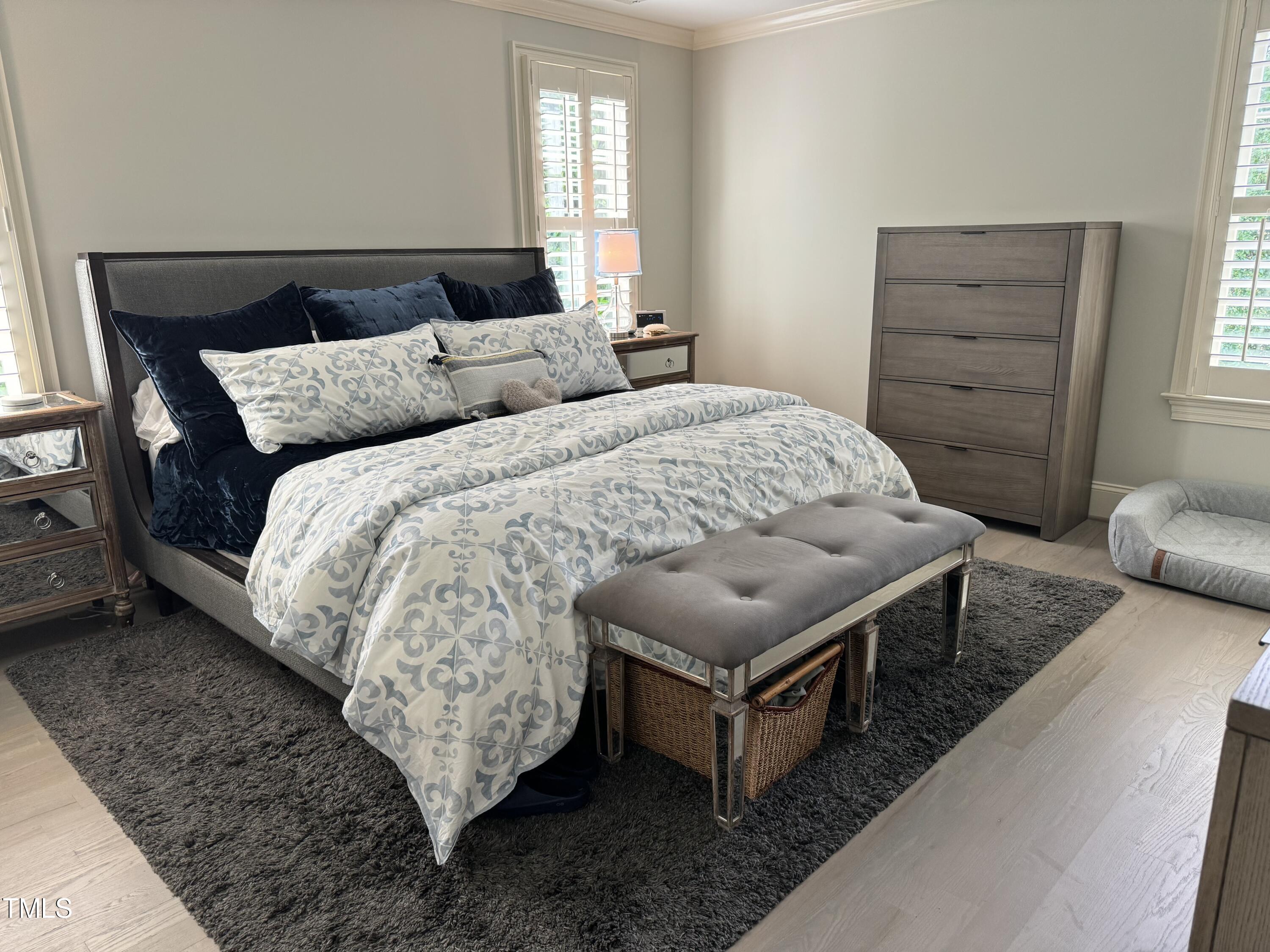 535 Guilford Circle Raleigh, NC 27608 - Photo 16 of 30 a bed sitting in a bedroom next to a window with dresser