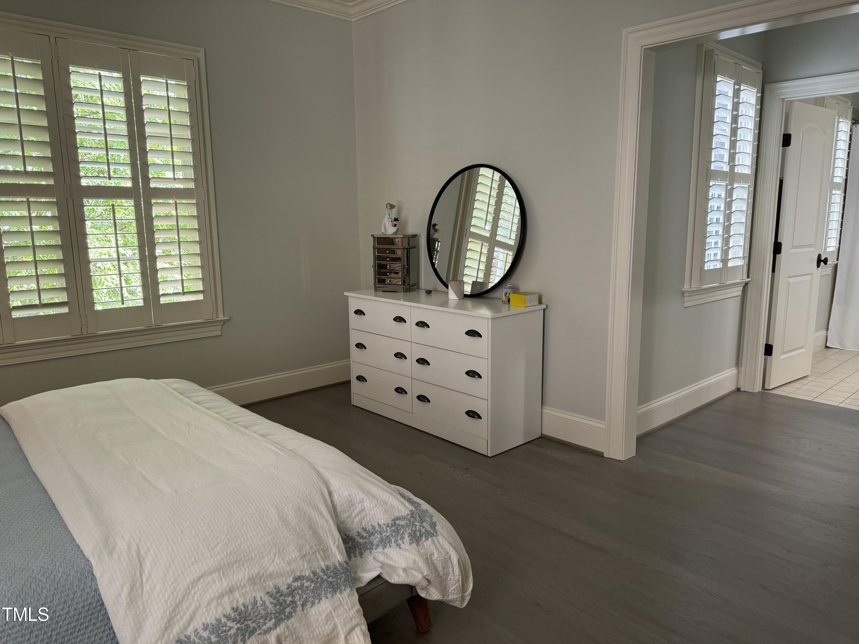535 Guilford Circle Raleigh, NC 27608 - Photo 20 of 30 a bedroom with a bed and a dresser