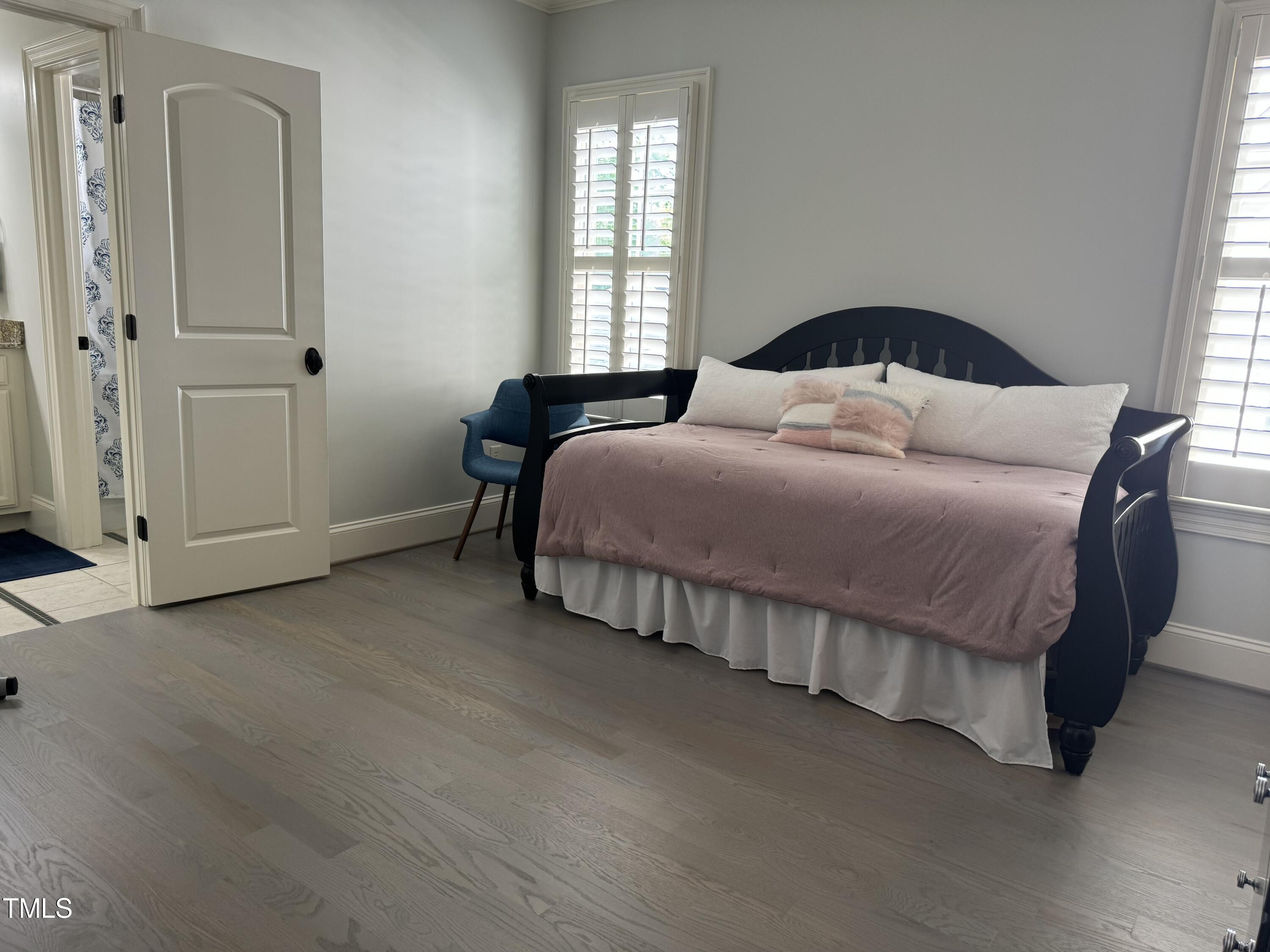 535 Guilford Circle Raleigh, NC 27608 - Photo 21 of 30 a bedroom with a bed and window