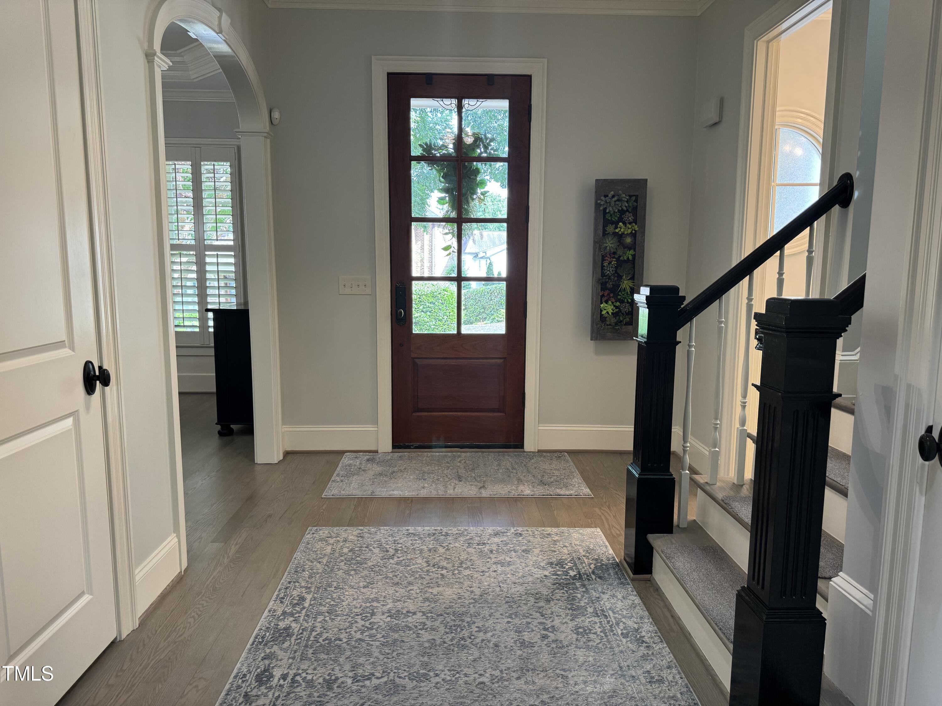 535 Guilford Circle Raleigh, NC 27608 - Photo 4 of 30 a view of entryway with wooden floor and stairs