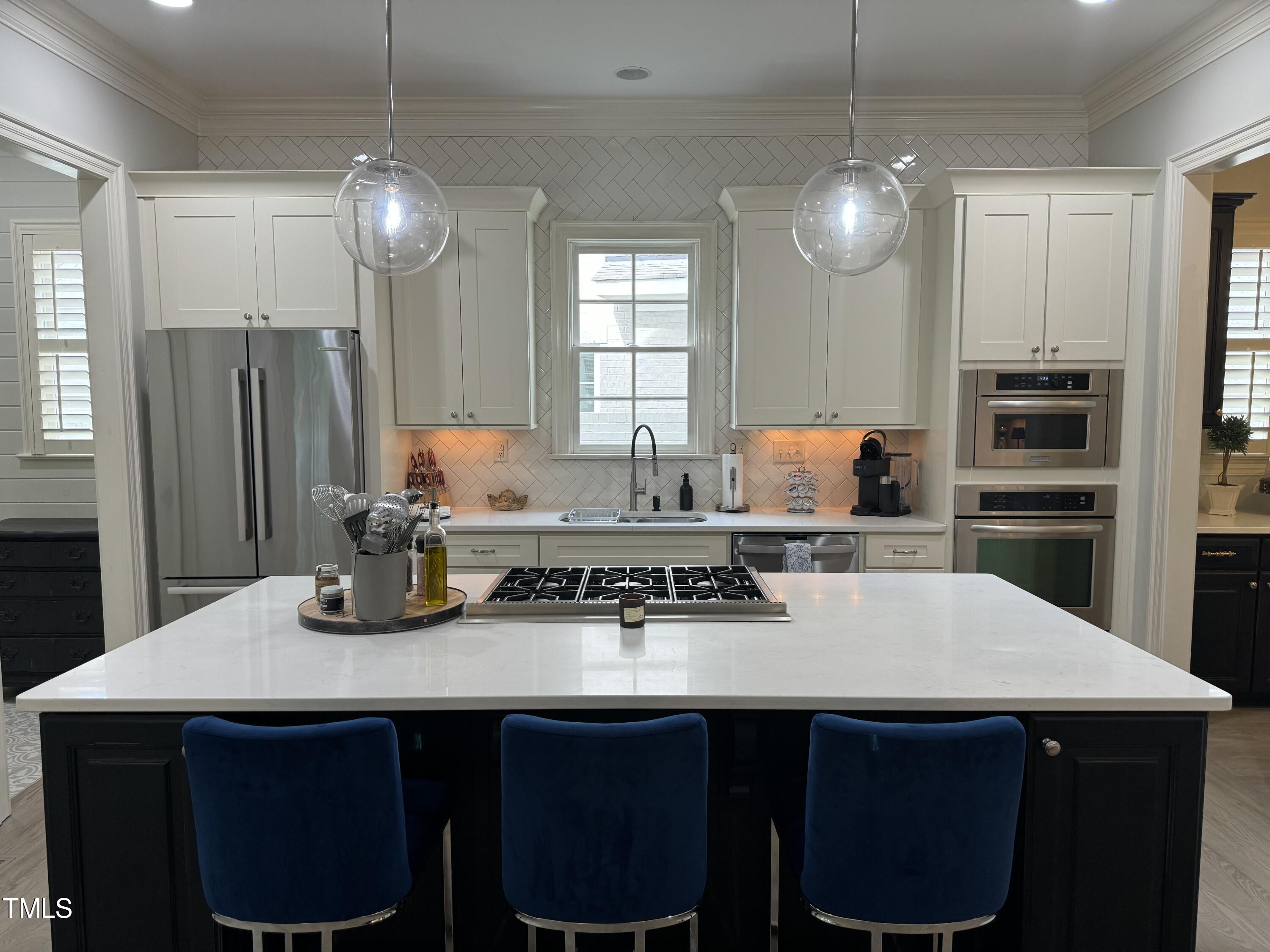 535 Guilford Circle Raleigh, NC 27608 - Photo 9 of 30 a kitchen with a dining table chairs and refrigerator