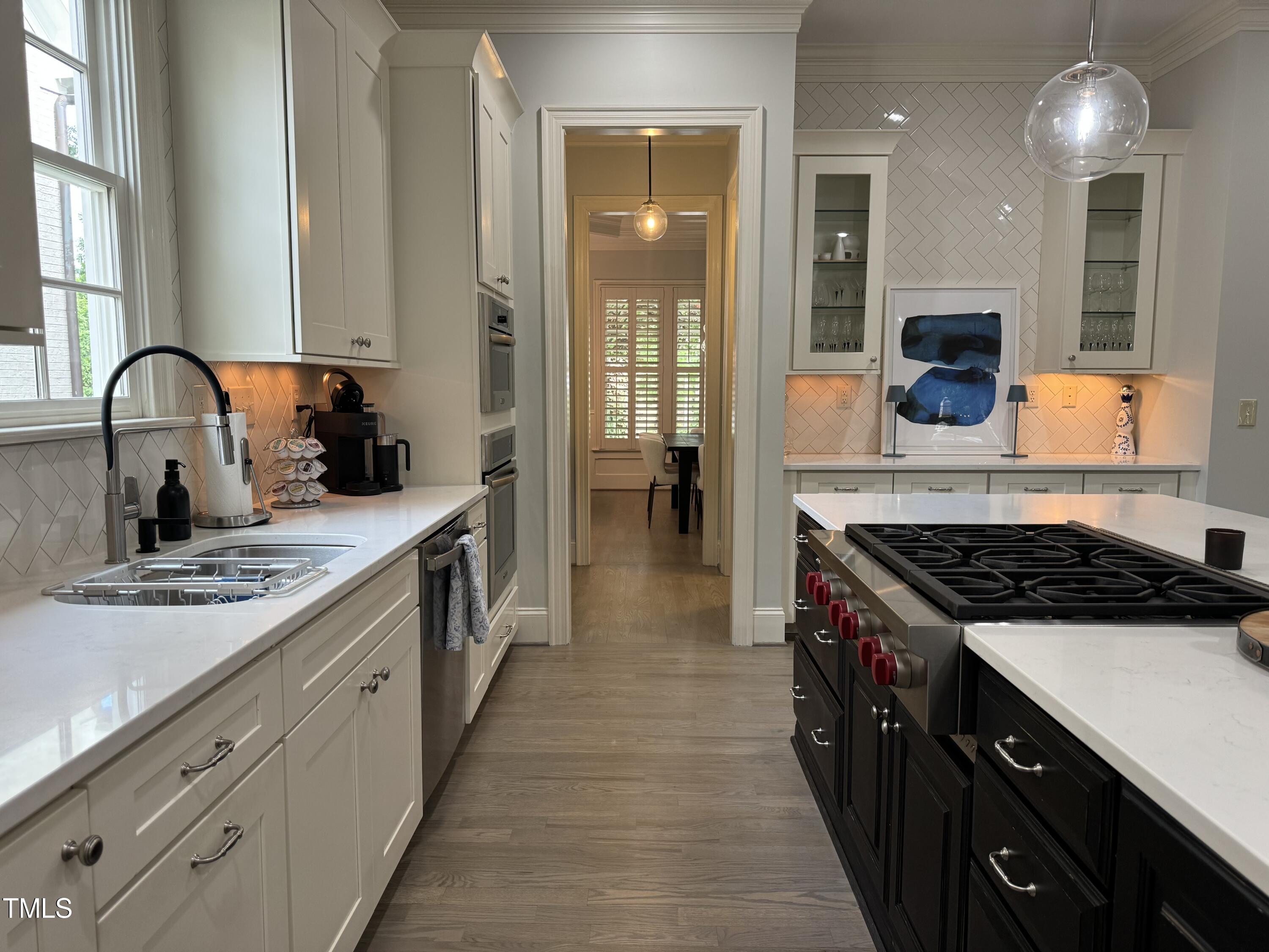 535 Guilford Circle Raleigh, NC 27608 - Photo 10 of 30 a kitchen with kitchen island a sink stove and cabinets