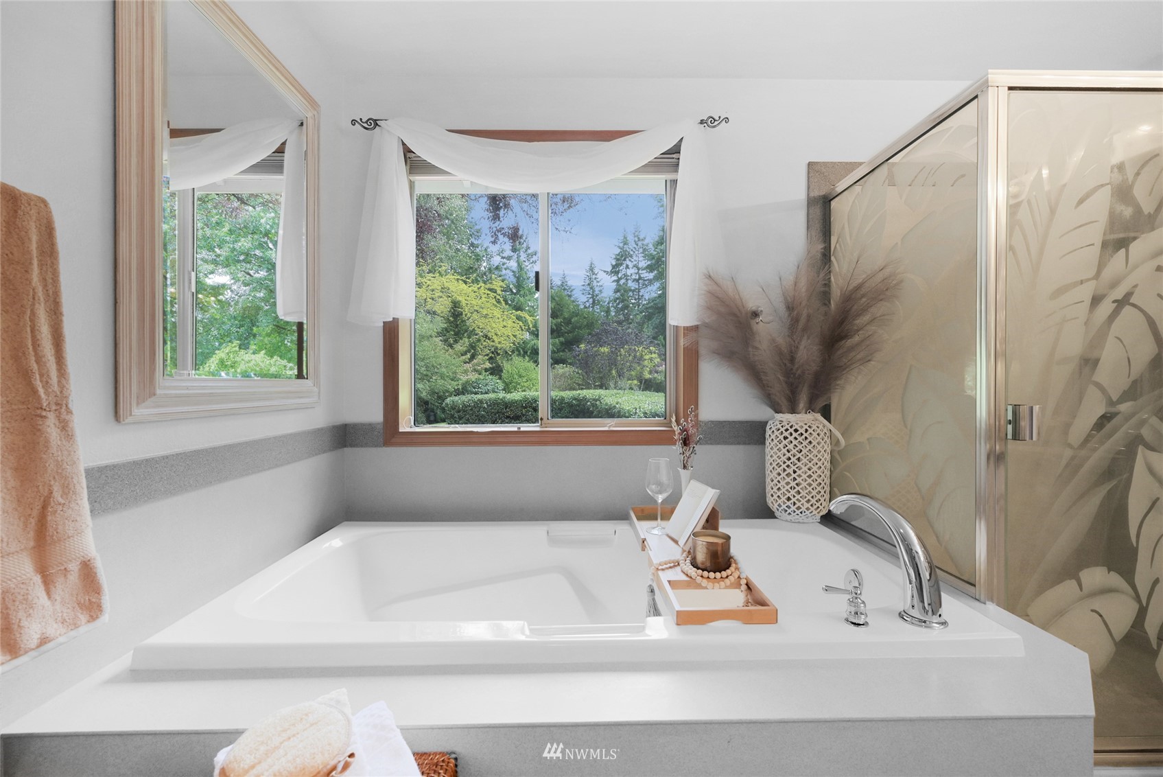 18203 Bellflower Road Bothell, WA 98012 - Photo 23 of 37 a white bath tub sitting in a bathroom next to a window