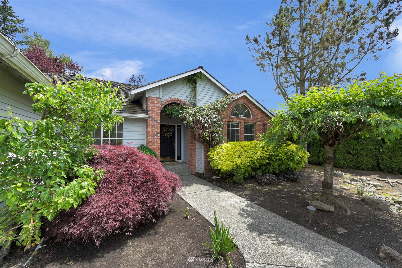 18203 Bellflower Road Bothell, WA 98012 - Photo 3 of 37 a front view of a house with a yard and garage