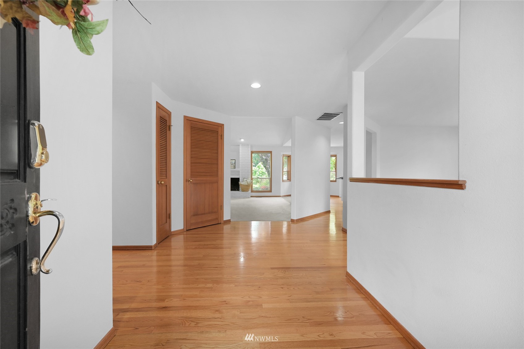 18203 Bellflower Road Bothell, WA 98012 - Photo 5 of 37 a view of a hallway view with wooden floor and a bathroom