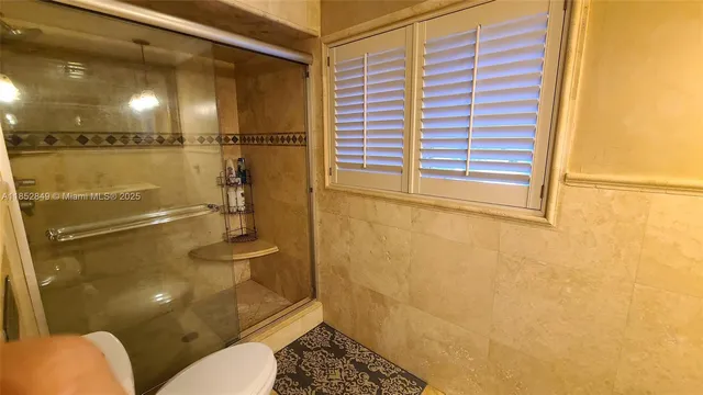 a bathroom with a toilet sink and shower