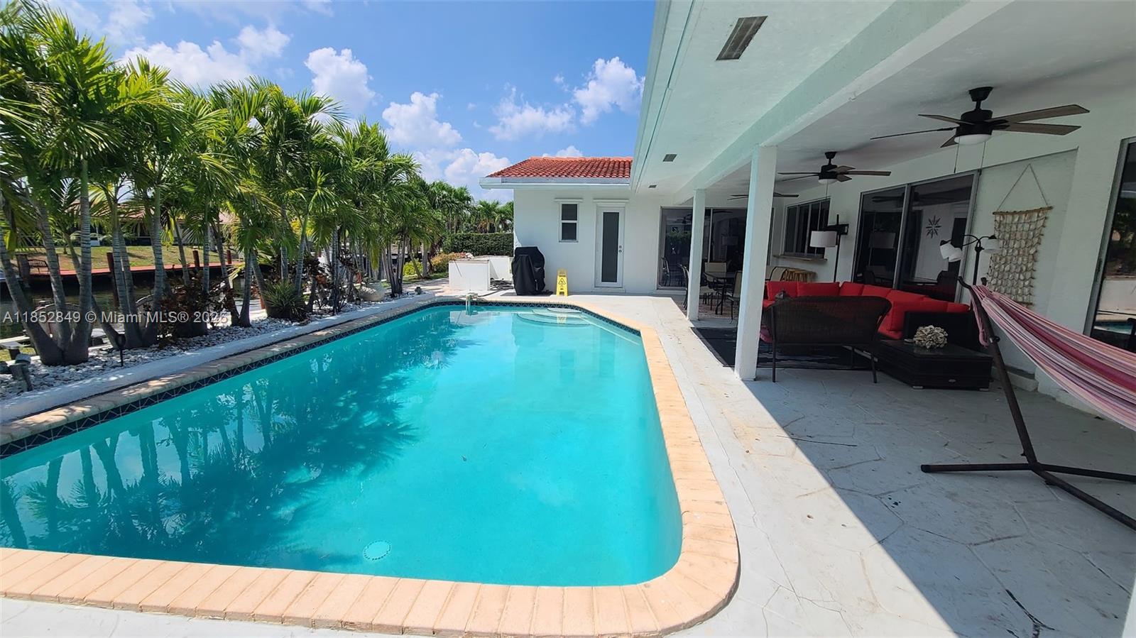 4211 Northeast 25th Avenue Lighthouse Point, FL 33064 - Photo 16 of 29 a view of a swimming pool with a patio