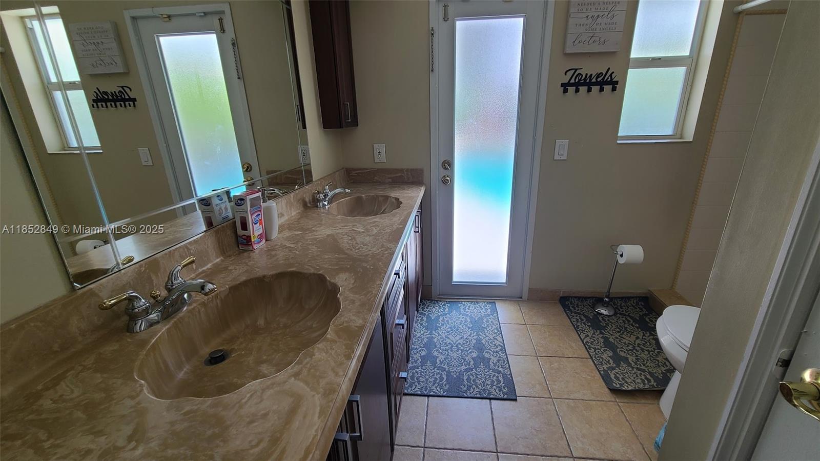 4211 Northeast 25th Avenue Lighthouse Point, FL 33064 - Photo 18 of 29 a bathroom with a granite countertop sink and a mirror