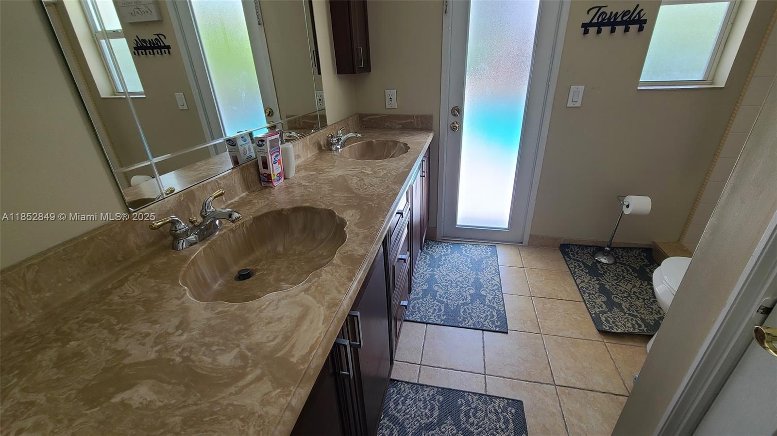4211 Northeast 25th Avenue Lighthouse Point, FL 33064 - Photo 19 of 29 a bathroom with a sink a mirror and vanity