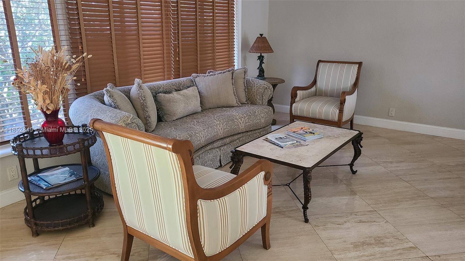 4211 Northeast 25th Avenue Lighthouse Point, FL 33064 - Photo 2 of 29 a living room with furniture and a window