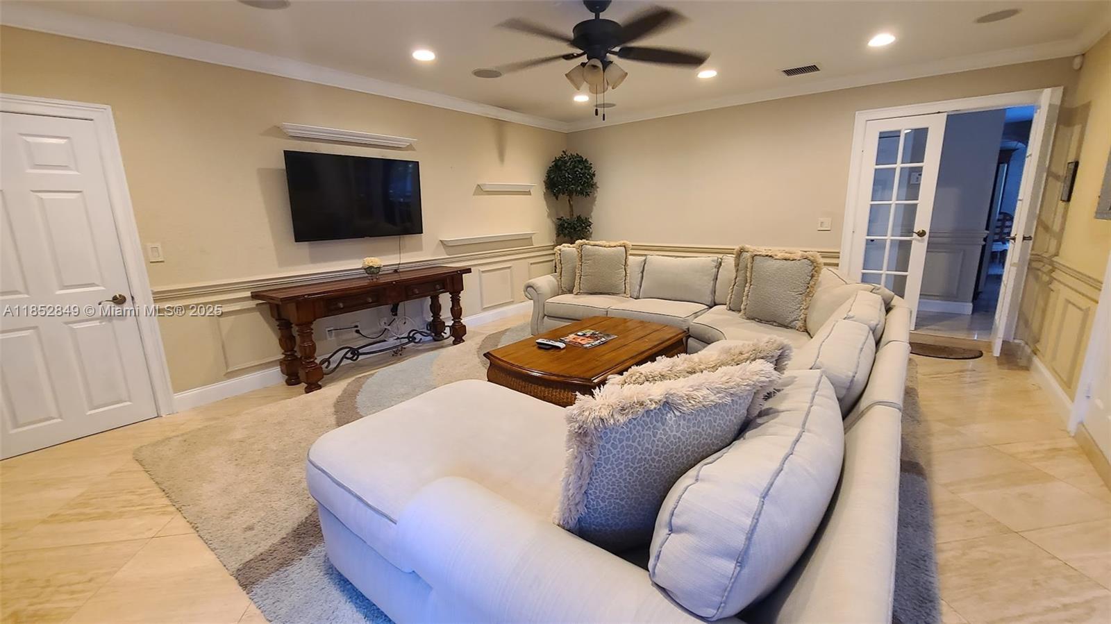4211 Northeast 25th Avenue Lighthouse Point, FL 33064 - Photo 22 of 29 a living room with furniture and a flat screen tv