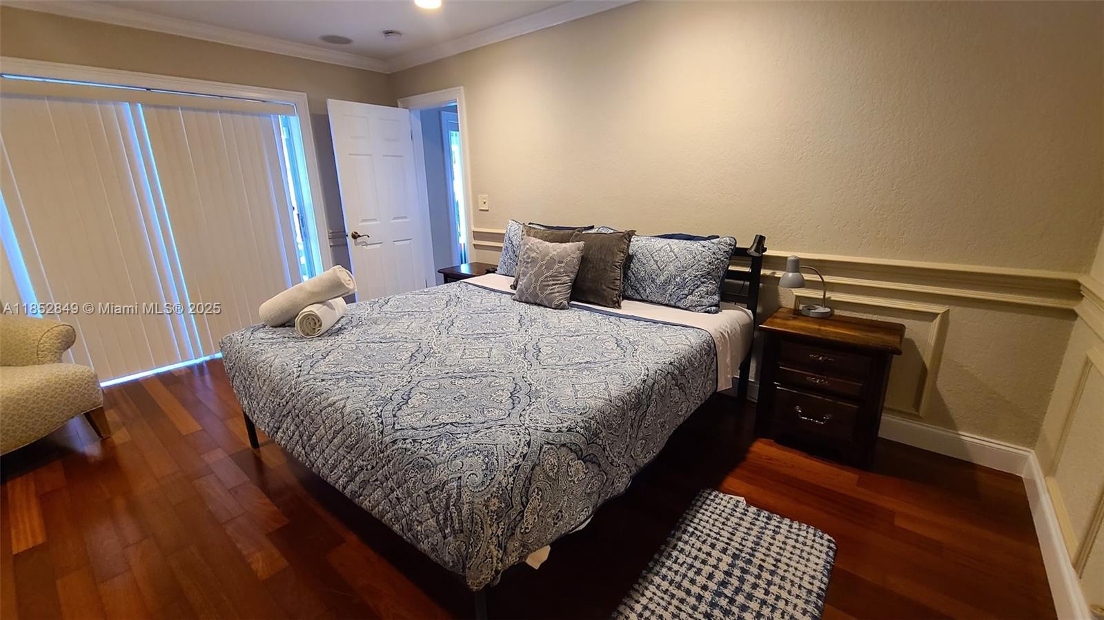 4211 Northeast 25th Avenue Lighthouse Point, FL 33064 - Photo 24 of 29 a bed sitting in a bedroom next to a window