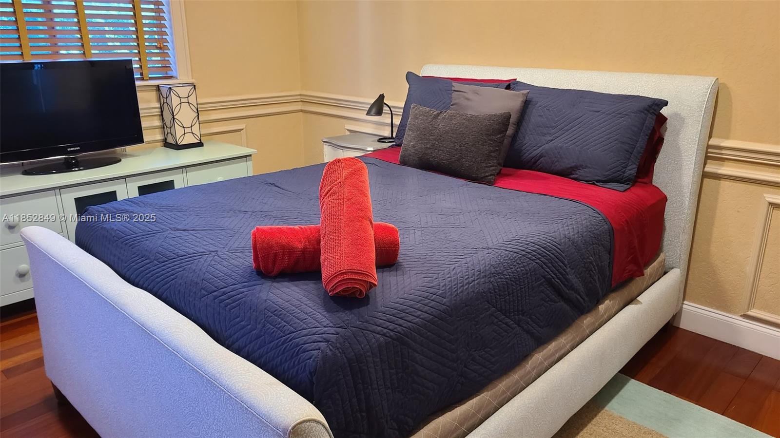 4211 Northeast 25th Avenue Lighthouse Point, FL 33064 - Photo 26 of 29 a bedroom with a bed and a flat screen tv