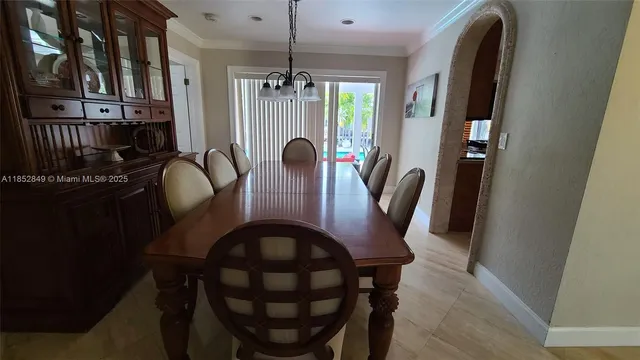 a view of a dining room with furniture and chandelier