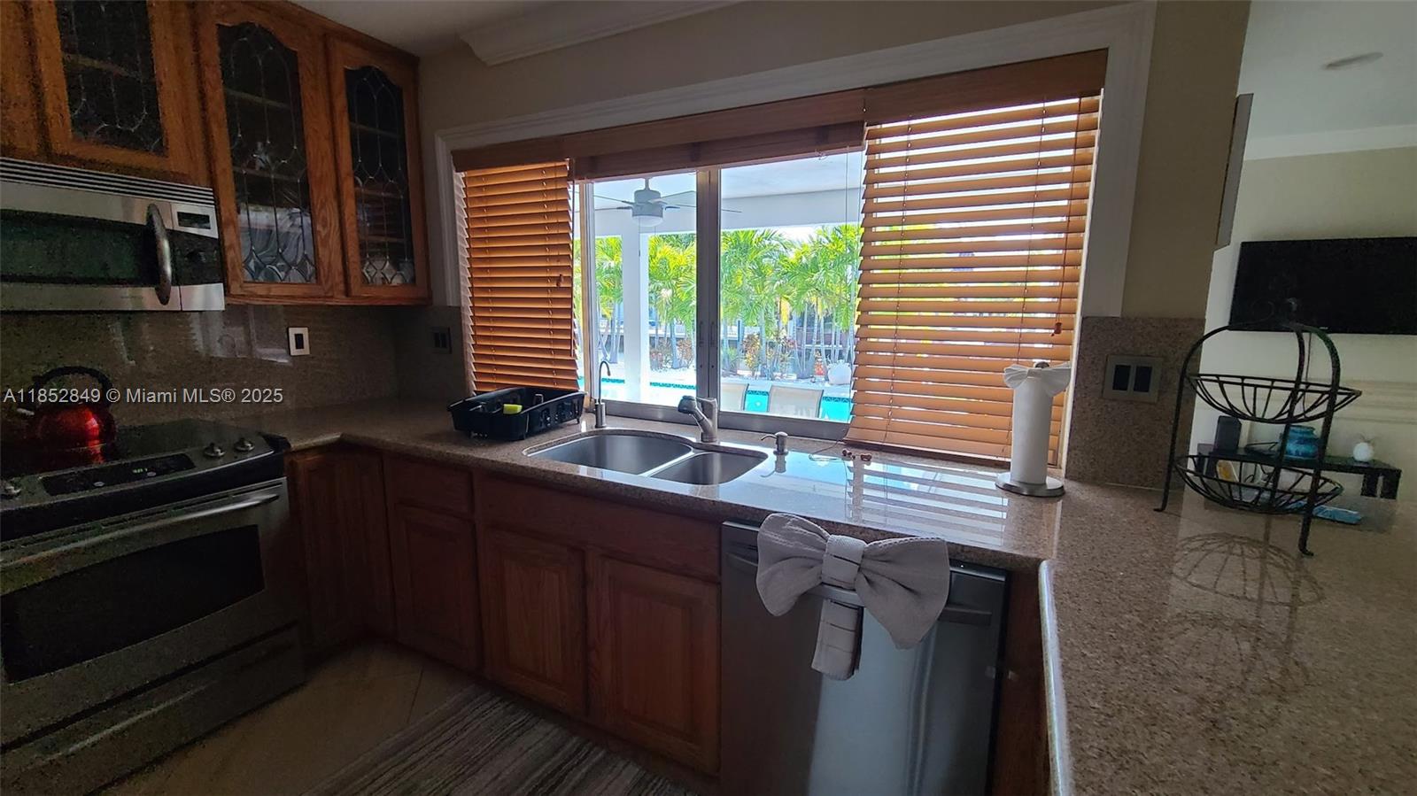 4211 Northeast 25th Avenue Lighthouse Point, FL 33064 - Photo 7 of 29 a kitchen with a sink and large window