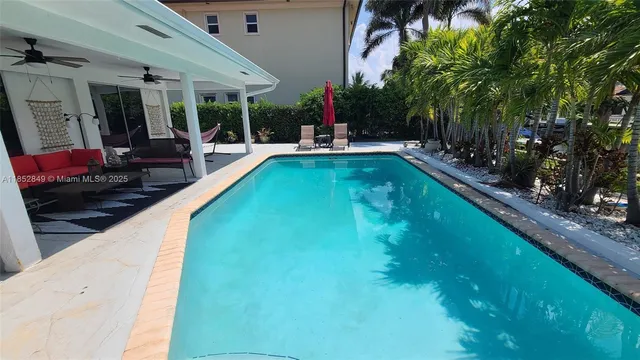 a view of swimming pool with outdoor seating