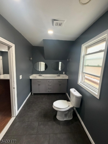 166 Renner Avenue, Unit 3 Newark, NJ 07112 - Photo 13 of 24 a bathroom with a toilet sink and mirror