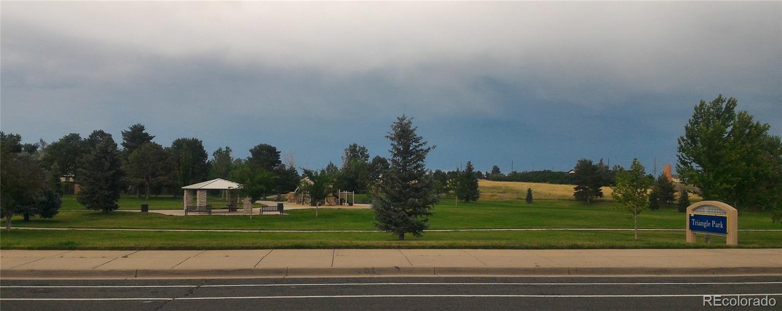 1689 Ensenada Way Aurora, CO 80011 - Photo 11 of 15 a view of a fountain in front of a houses
