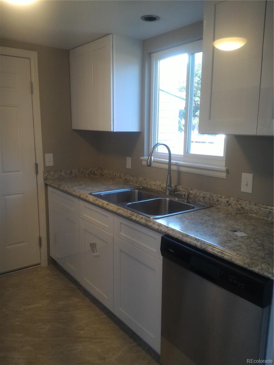 1689 Ensenada Way Aurora, CO 80011 - Photo 14 of 15 a kitchen with a sink and cabinets
