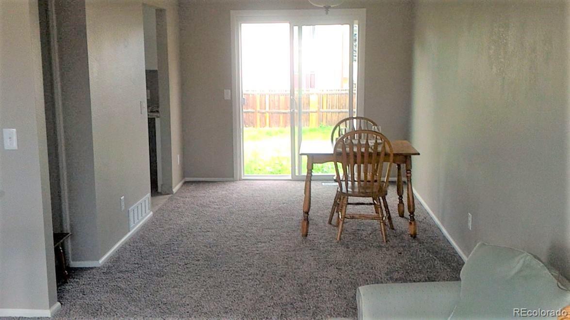 1689 Ensenada Way Aurora, CO 80011 - Photo 2 of 15 a view of a livingroom with a dining table & chairs