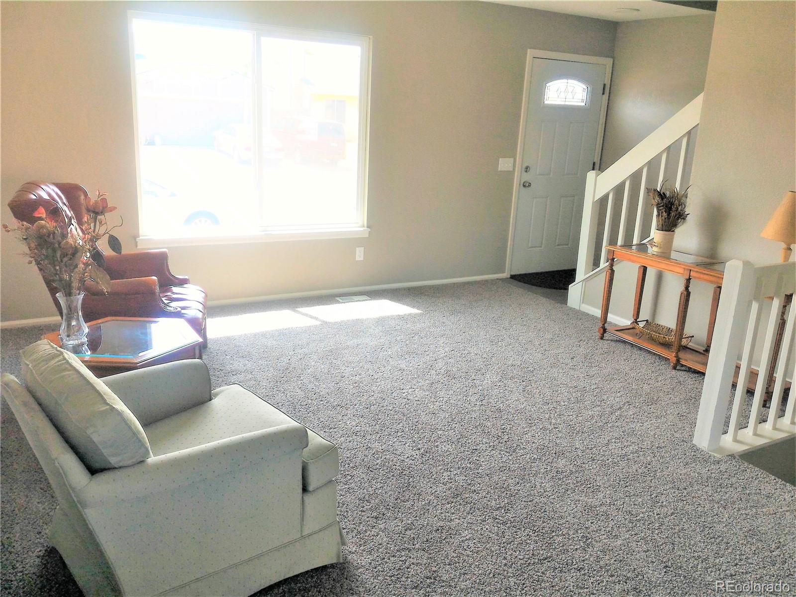1689 Ensenada Way Aurora, CO 80011 - Photo 3 of 15 a living room with furniture and a window