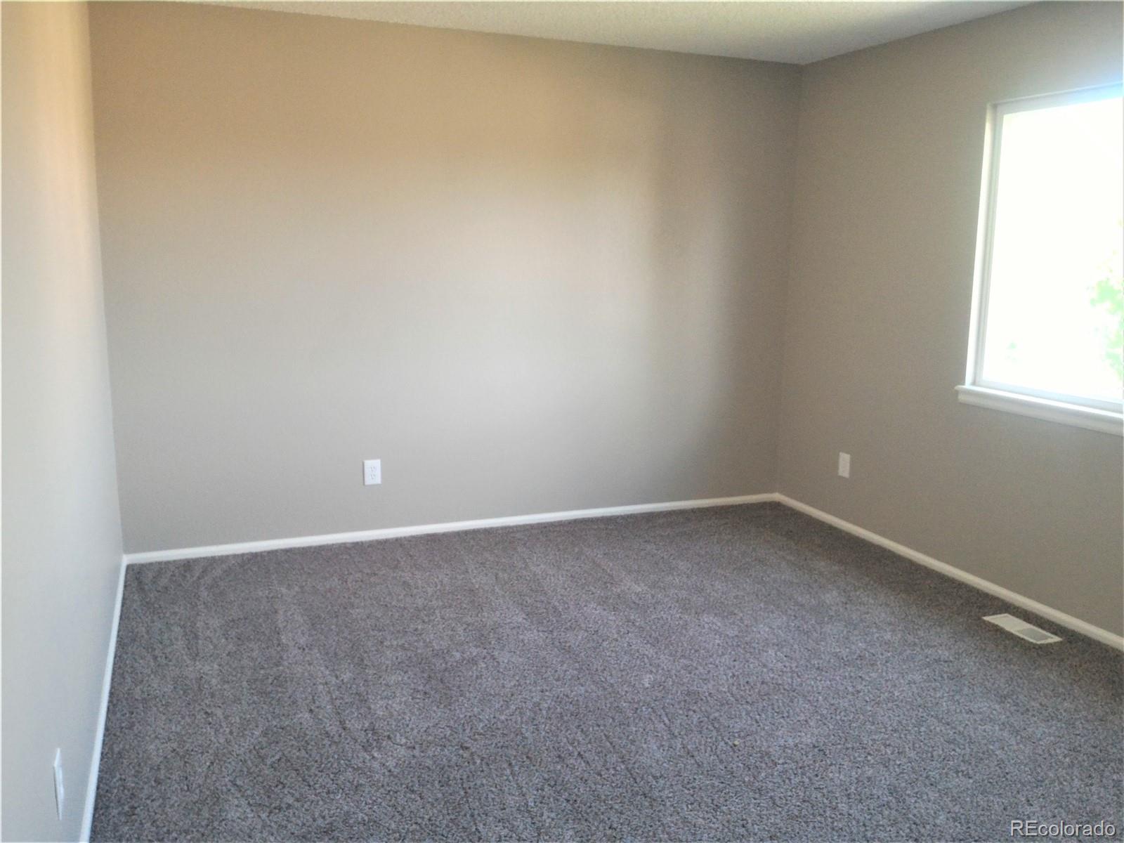 1689 Ensenada Way Aurora, CO 80011 - Photo 4 of 15 a view of an empty room and a window