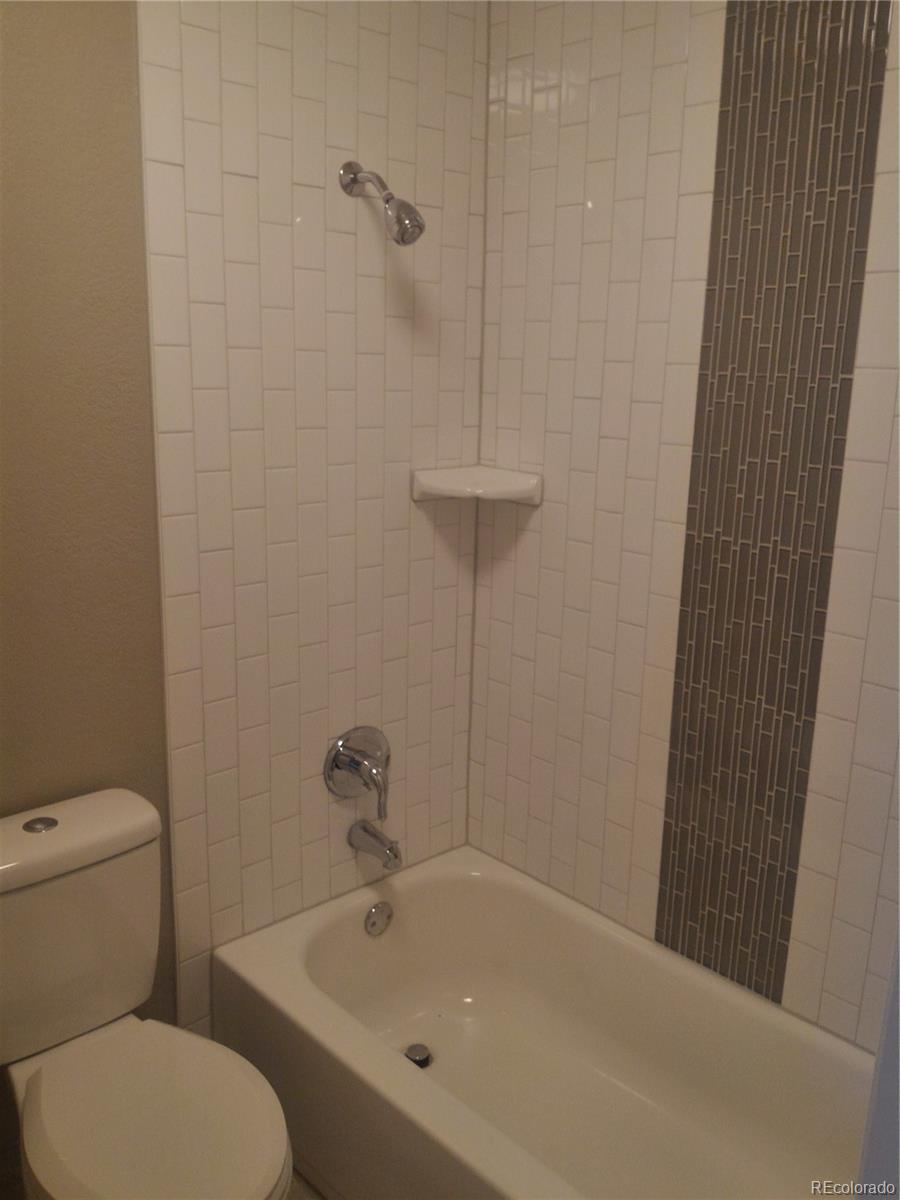 1689 Ensenada Way Aurora, CO 80011 - Photo 7 of 15 a white bath tub sitting next to a white toilet