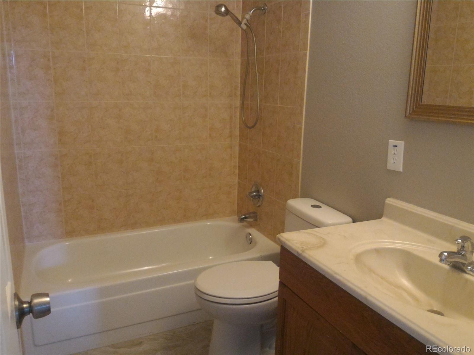 1689 Ensenada Way Aurora, CO 80011 - Photo 8 of 15 a bathroom with a sink toilet and shower