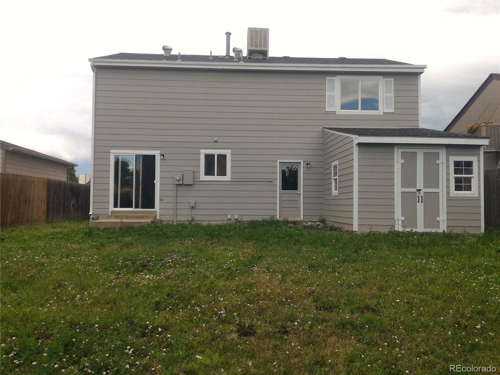 1689 Ensenada Way Aurora, CO 80011 - Photo 10 of 15 a view of front of a house with a yard