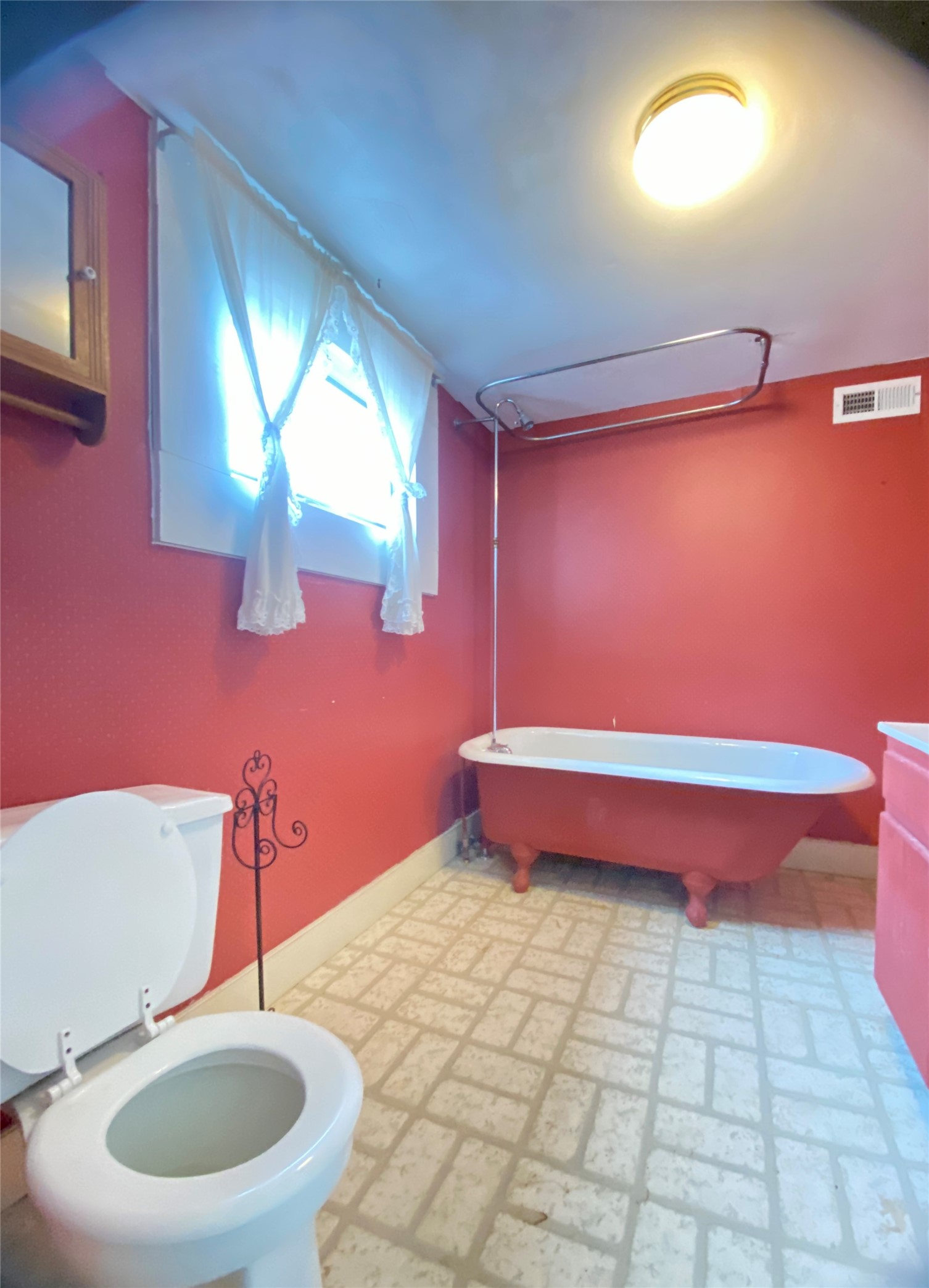 108 West Liberty Street Washington, GA 30673 - Photo 14 of 24 a bathroom with a sink a toilet and mirror