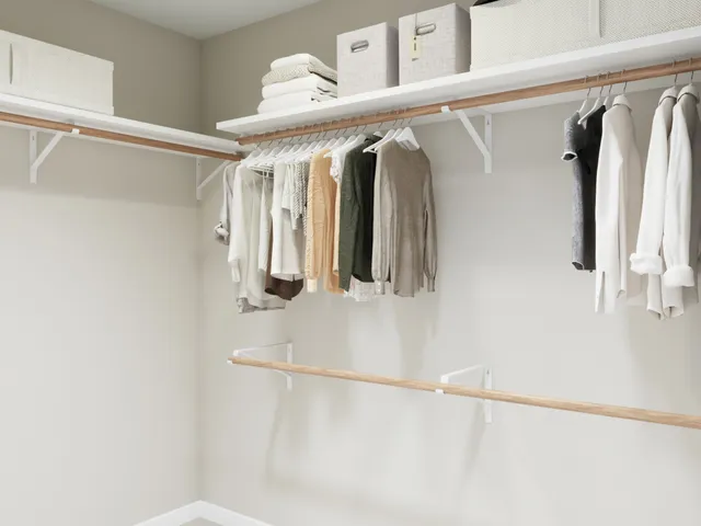 a view of a house with a big yard potted plants and large tree