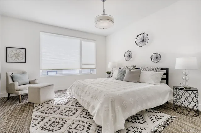 a bedroom with a bed and a chair