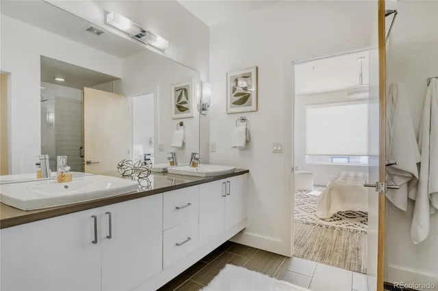 a bathroom with a granite countertop sink a mirror and a shower