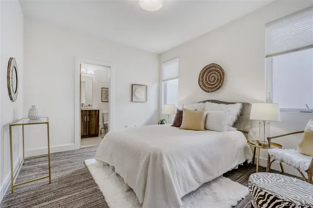 a bedroom with a bed and a table