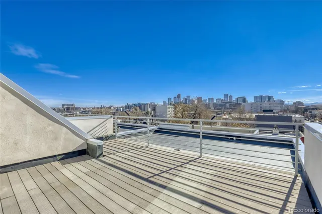 a view of roof deck with patio and wooden floor