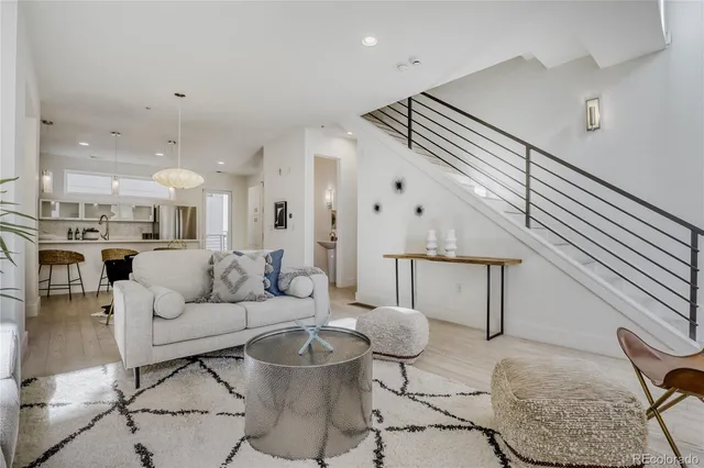 a living room with furniture and kitchen view