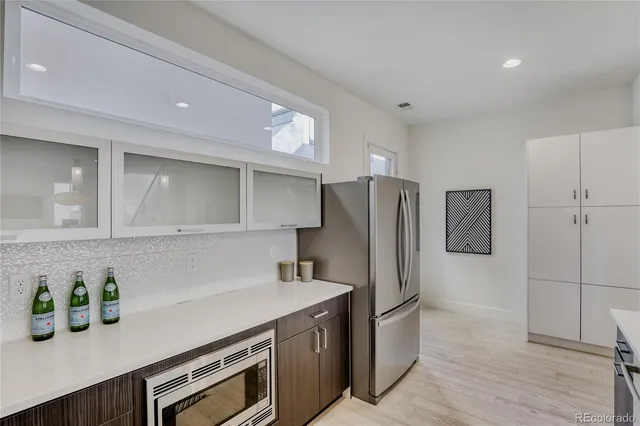 a kitchen with stainless steel appliances a refrigerator and a sink