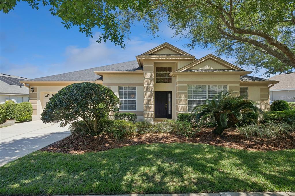 1584 Cherry Ridge Drive Lake Mary, FL 32746 - Photo 1 of 62 a front view of a house with a yard