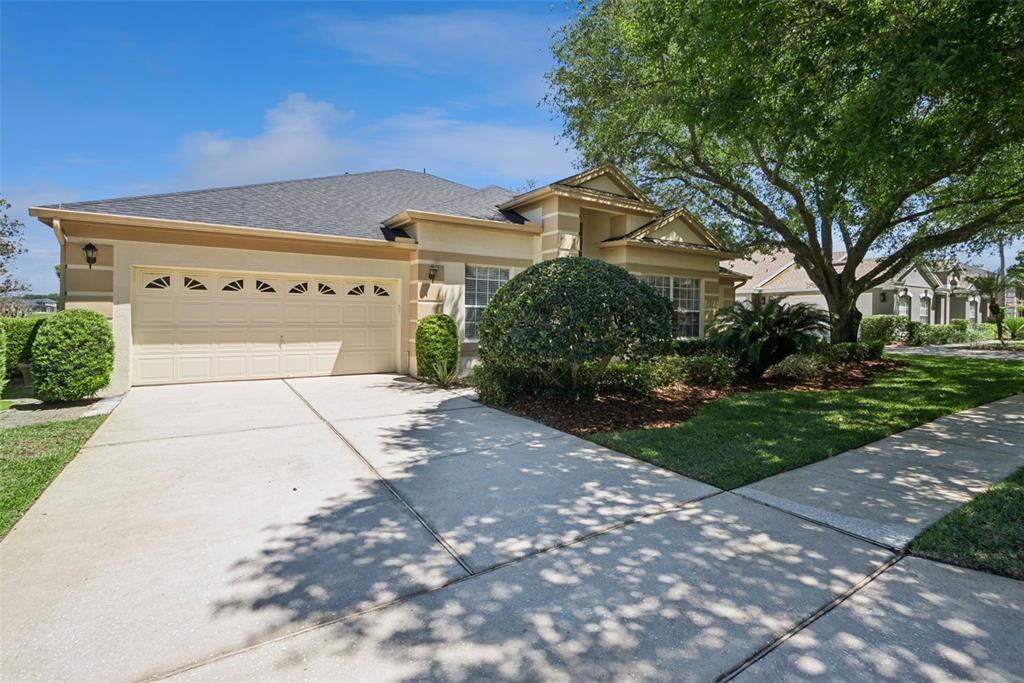1584 Cherry Ridge Drive Lake Mary, FL 32746 - Photo 2 of 62 a front view of a house with a yard and garage