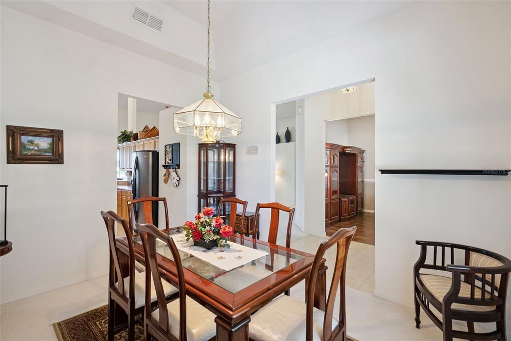 1584 Cherry Ridge Drive Lake Mary, FL 32746 - Photo 23 of 62 a view of a dining room with furniture and a chandelier